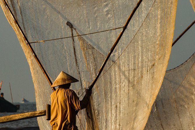 Vietnam Fishing village photography tours - Pulling a net that stretches across the water